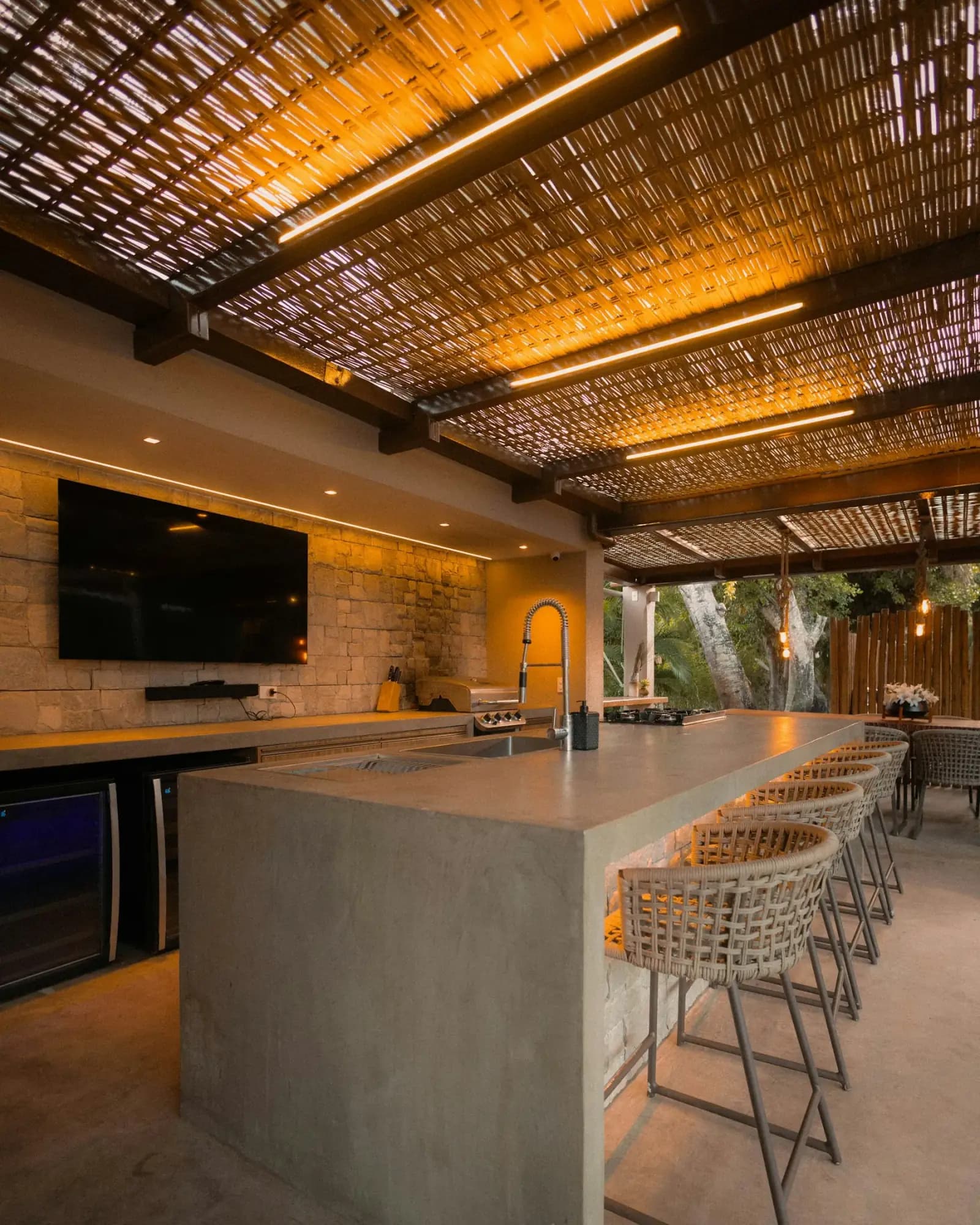 Modern masonry outdoor kitchen with bar seating by MCG Top Masonry